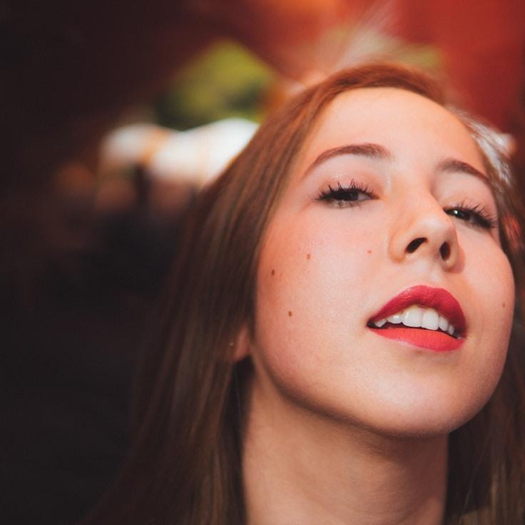 Ava Singh, Lead Design Curator at HarvestLumenCanvas, reviewing corporate floral arrangements